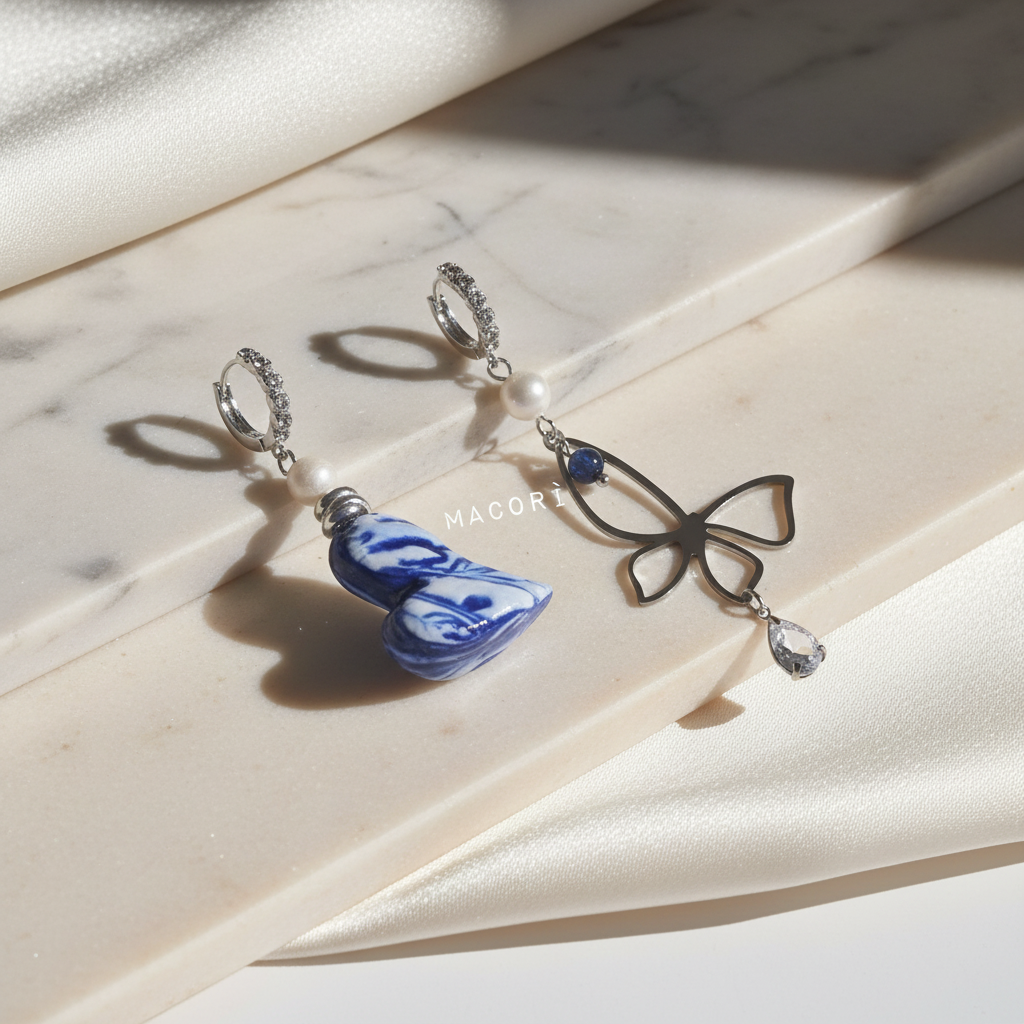 Orecchini asimmetrici su sfondo elegante